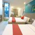 Legazpi Tourist Inn in Legazpi City room with two beds, desk, bathroom, and seating area