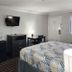 Motel 6 Crowley, La room with bed, TV, desk, dresser and mini fridge in Crowley