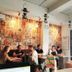 The Packer Lodge Yogyakarta lobby with guests seated by a bright entrance in Yogyakarta