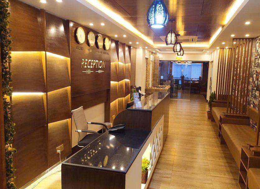 Hotel Grand View in Sylhet reception area with warm lighting, front desk, and wood-paneled seating