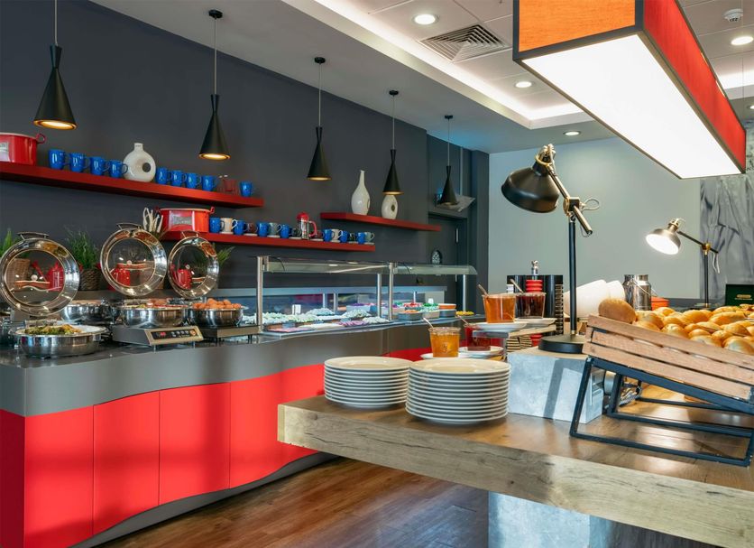 ibis Ankara Airport buffet breakfast area with pastries, plates, and hot dishes in Esenboğa