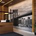 Hotel Mirage Brooklyn lobby with wooden reception desk and black-and-white Brooklyn bridge wall mural