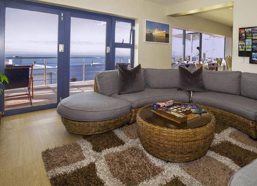 Magellans Hotel Simon's Town lounge with sea-view balcony and sectional sofa