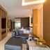 Kudo Hotel & Beach Club (Adults Only) Patong suite with living area, kitchenette, bed and fruit tray