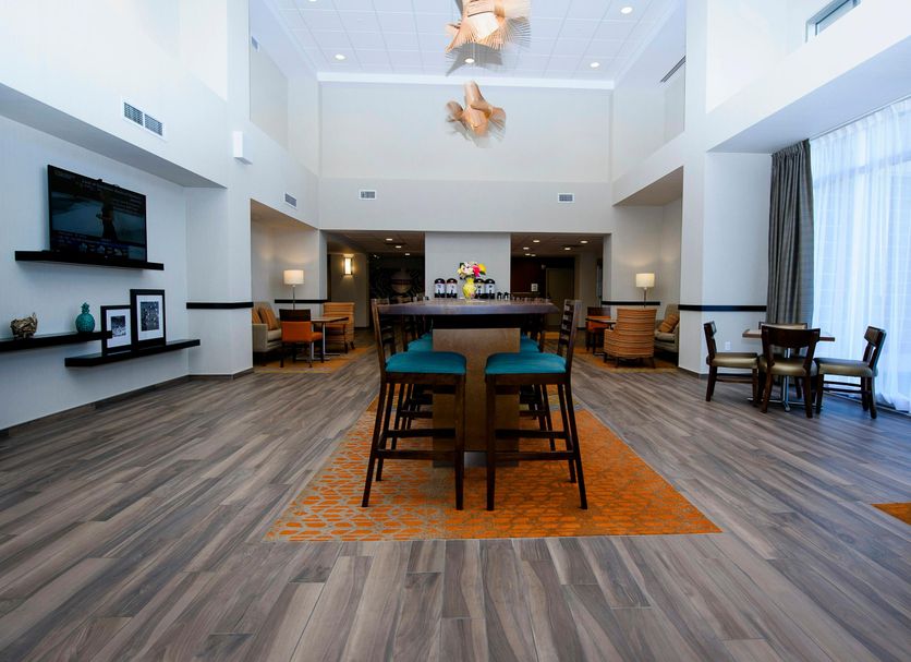 Hampton Inn & Suites by Hilton Truro lobby with seating area and high ceiling in Truro