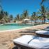 Ocean Beach Resort & Spa, Malindi: poolside loungers beside a tropical pool and palm trees