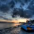 Jb City Hotel in Johor Bahru with sunset over the waterfront and a beached boat
