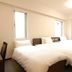 Ab Hotel Toyota Motomachi guest room with two beds and two narrow windows in Toyota