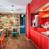 Hotelf1 Bordeaux Nord Lormont dining area with colorful chairs and red coffee station in Lormont