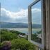 Bryn Melyn Apartments, Barmouth: open windows with sea and hill views over green gardens