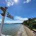 Sri Phairin Resort in Chanthaburi with a beachfront view, palm trees, and calm sea under blue sky