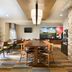 Fairfield Inn by Marriott Kankakee Bourbonnais breakfast area with tables, chairs and stone wall in Bourbonnais