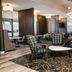 Residence Inn by Marriott Grand Rapids Downtown lounge with plaid chairs, tables and stone fireplace