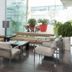 Port Elche in Elche: modern hotel lounge with glass wall, seating area, and potted plants
