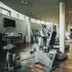 Gut Lauterbad Hotel fitness room with exercise bikes, treadmills and mirrored workout area in Freudenstadt