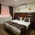 Marlight Boutique Hotel in Izmir guest room with a double bed, dark drapes, and wall-mounted air conditioner