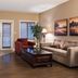The Castle at Swan Lake, Vernon: spacious suite living room with dining table, sofa, armchair and coffee table