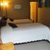 Tofino Swell Lodge in Tofino guest room with two beds, lamp, framed wall art, and window