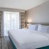 Hilton Garden Inn Jacksonville Ponte Vedra Sawgrass guest room with king bed and balcony view