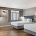 Best Western Plus Edmundston Hotel room with two beds, gray walls, wood floors and window