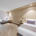 Haberfield Hotel in Sydney room with two single beds, desk, chairs, and wood-look flooring