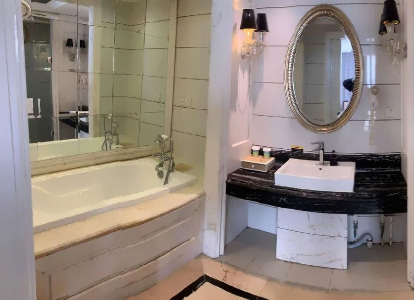 Landi Fashion Park Beijing bathroom with soaking tub, vanity sink, and glass-enclosed shower