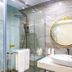 Mai Hotel Hanoi bathroom with glass shower, wall mirror, vessel sink, and towel rack
