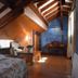 Hospedium Hacienda Las Cavas in Olmedo, attic room with exposed wooden beams and rustic seating area