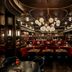 The Reserve at Park MGM in Las Vegas, luxe restaurant with red banquettes and dramatic chandelier