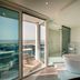 Hotel Panoramic Caorle bathroom with freestanding tub and glass doors opening to a sea-view terrace