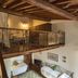 Villa dei Papiri in Siracusa: loft-style room with wrought-iron railing and twin beds below
