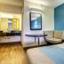 Motel 6 Dickson, TN guest room with bed, desk, chair, sink area, and blue accent wall