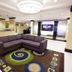Holiday Inn Express & Suites Detroit North - Troy lobby with sectional sofa and colorful rug