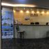 Ahla Tala Hotel Aqaba reception desk with two chairs and promotional banners