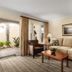Brisas Del Mar Inn at the Beach in Santa Barbara: guest room with sofa, armchair and patio doors to courtyard