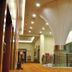 Ros-In Hotel Yogyakarta hallway with a tall modern column and glass railing in Yogyakarta