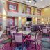 Holiday Inn Express & Suites Bowling Green lobby with seating area and colorful patterned carpet