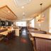 Hotel AZ Kumamoto Hokubu restaurant dining area with wooden tables and booth seating in Kumamoto