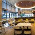 SpringHill Suites by Marriott Seattle Issaquah lobby lounge with curved seating, tables and large windows