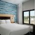 TownePlace Suites by Marriott Savannah Airport guest room with bed, blue accent wall and window view in Savannah