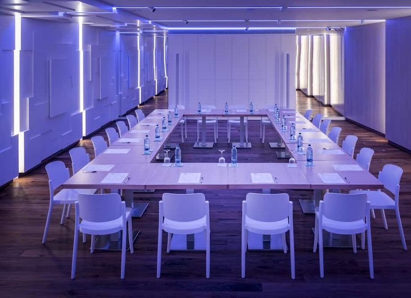 Hotel Alhambra in Santa Susanna meeting room with long conference table and purple lighting