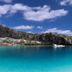 Stella Maris Resort Club in Stella Maris with turquoise bay, rocky cliffs and a small boat