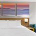 Days Inn by Wyndham Harrisonburg guest room with king bed and mountain landscape artwork above the headboard