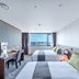 Hotel Shalom Jeju in Jeju City: twin room with city or ocean view and desk by window