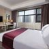 Holiday Inn & Suites Hulunbuir guest room with city view, desk, and large window