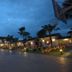 The House of Water in Dongshan Township, palm-lined hotel pathway at dusk with lit cottages
