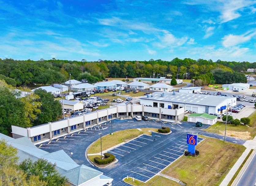 Motel 6 Moultrie, GA exterior with parking lot and blue sky in Moultrie