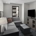 Hyatt House Raleigh Downtown/Seaboard Station suite with gray sectional, TV, and glimpse of bedroom in Raleigh
