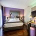 Leonardo Hotel Madrid City Center guest room with bed, desk, wall-mounted TV and mirror in Madrid