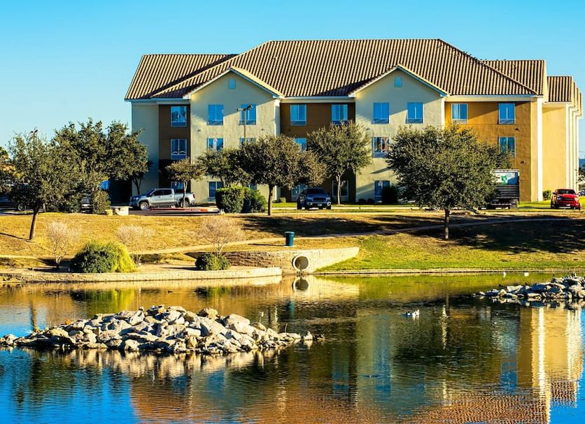 Staybridge Suites Laredo International Airport By IHG in Laredo beside a reflective pond and rocks